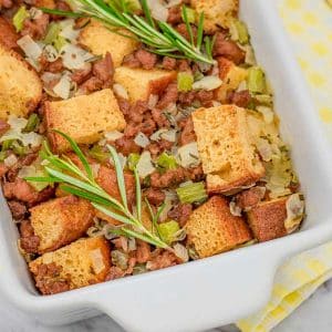 Keto sauasage and herb stuffing in a white baking dish.