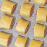 Keto sausage rolls pastry on a baking tray with baking paper.