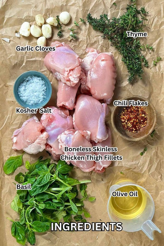 Garlic, chili, and basil boneless skinless chicken thigh fillets ingredients. Garlic cloves, chicken thigh fillets, thyme, chili flakes, salt, basil, and olive oil.